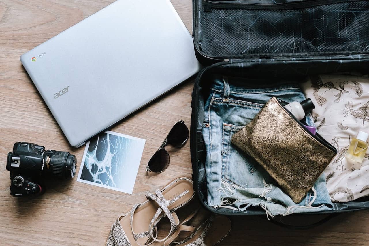 Suitcase with computer and camera, birds-eye view